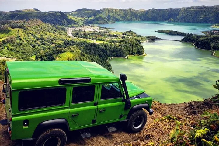 Bright green jeep parked overlooking the twin lakes of Sete Cidades.